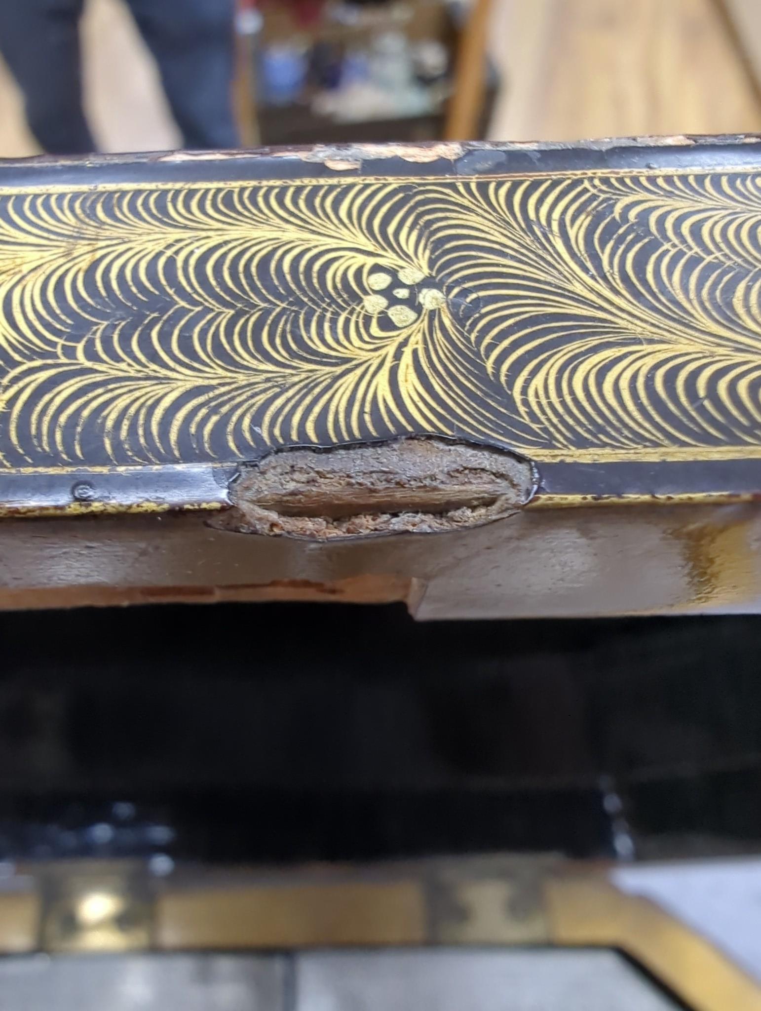 A 19th century Chinese chinoiserie lacquered sarcophagus form tea caddy, pewter lined interior with bone handles, 23cm